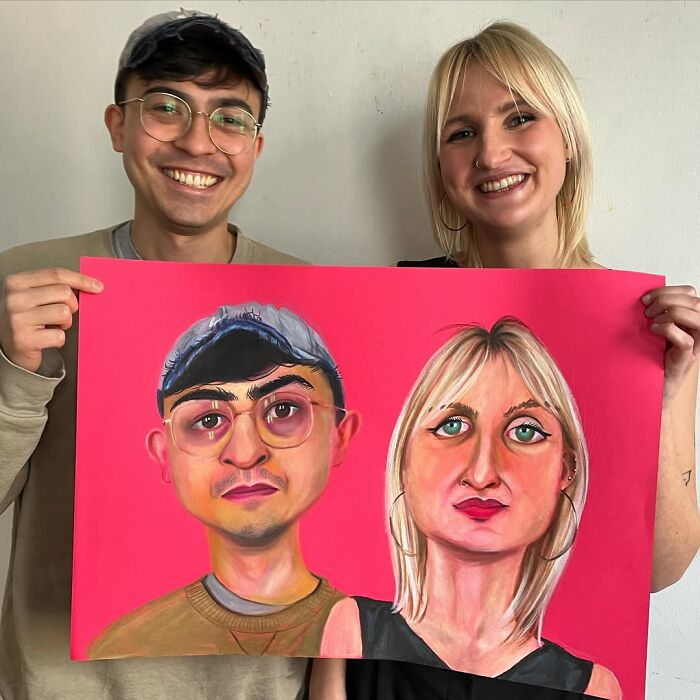 Two people hold expressive portrait artwork in vibrant colors.