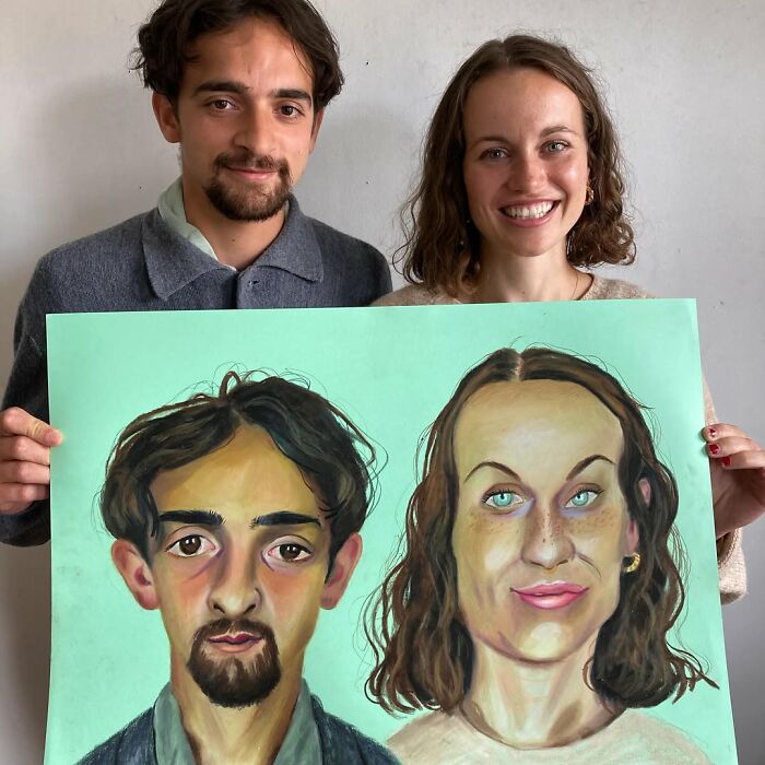 A British artist holds expressive portraits, showcasing unique artistic style.