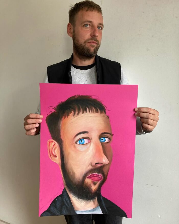 British artist holding an expressive portrait with a vibrant pink background, showcasing his unique artistic style.