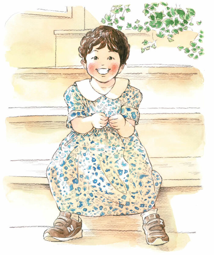Smiling child in a floral dress and sneakers sitting on steps, capturing a heartwarming moment.
