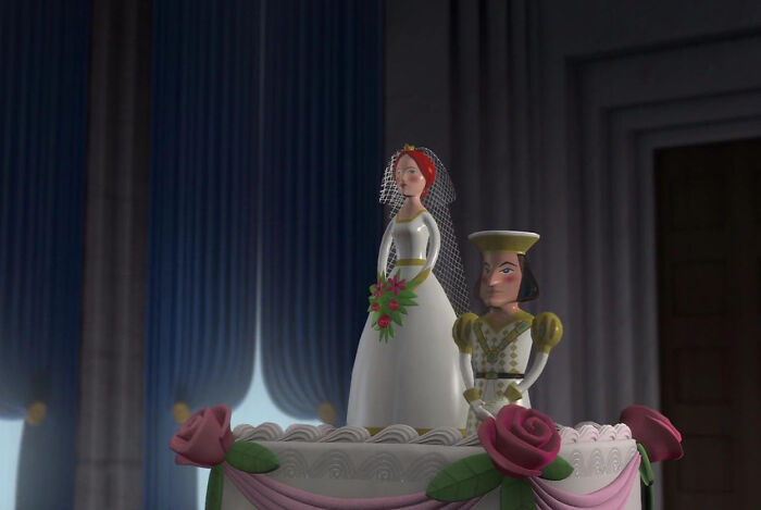 Bride and groom figurines as cake toppers at a wedding, showcasing traits in a whimsical setting.