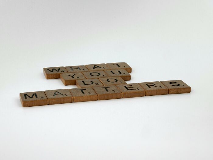 Scrabble tiles spell "What you do matters," emphasizing personal impact and traits.