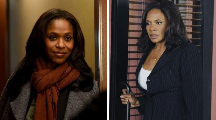 Two actors, one wearing a scarf and the other in a pinstripe blazer, depicting actors replaced mid-production.