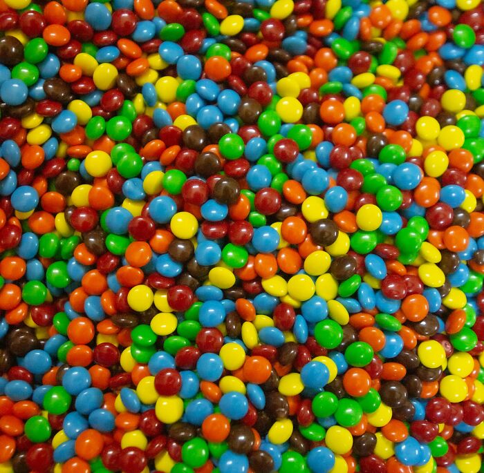 A colorful pile of candy hinting at a 'lifetime supply' experience with assorted flavors.