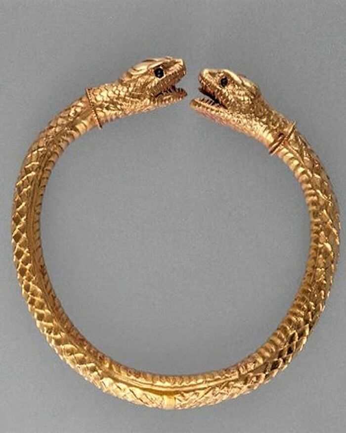 An ancient bracelet featuring twin serpent heads, showcasing intricate craftsmanship from thousands of years ago.