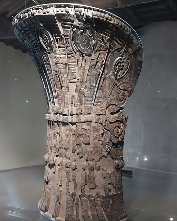 Ancient history artifact showcasing intricate carvings, displayed in a museum setting.