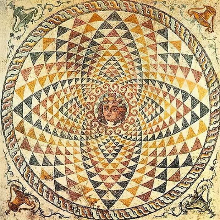 Intricate ancient mosaic with geometric patterns and central face, revealing ancient civilizations' art secrets.