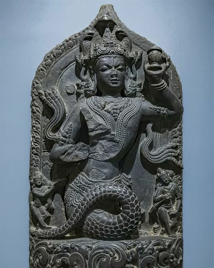 Ancient history relief sculpture depicting a figure with intricate carvings, illustrating historical art.