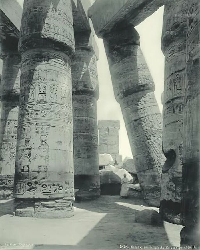 Ancient history image of the Karnak Temple's massive stone columns with intricate carvings.