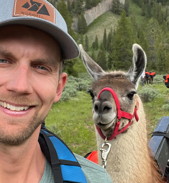 Man smiling outdoors with llama, representing Youtube star who passed away. Man smiling outdoors with llama, representing Youtube star who passed away.