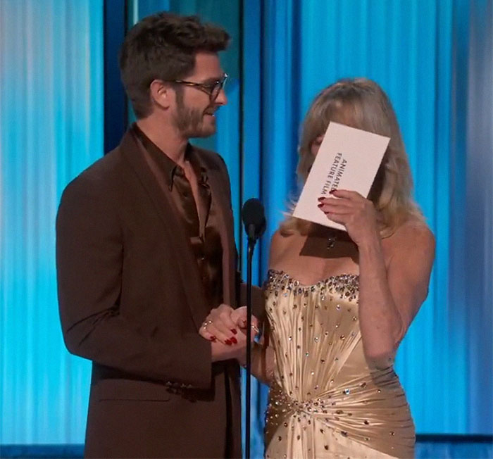 Andrew Garfield with Goldie Hawn at Oscars, sharing a heartfelt moment on stage.