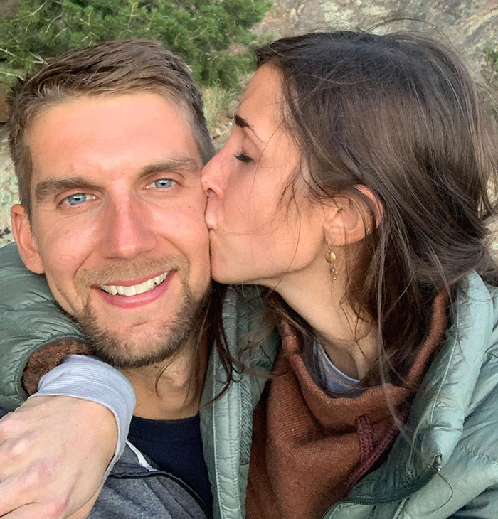 Smiling man kissed on cheek by woman, outdoors, representing a YouTube star. Smiling man kissed on cheek by woman, outdoors, representing a YouTube star.