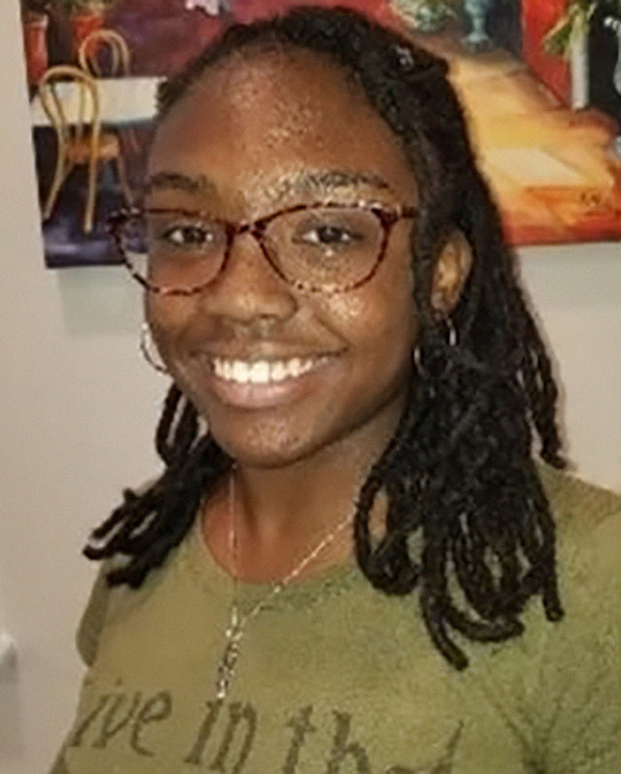 Smiling girl with glasses and braided hair, related to "Runaway Girl" missing person case.