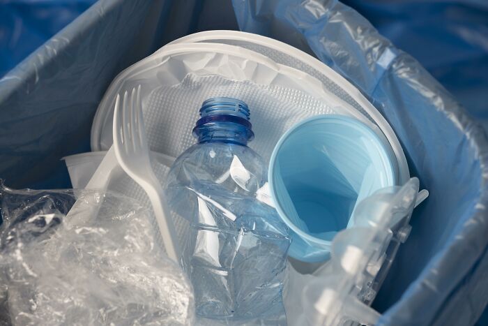 Recyclable plastic items in a bin, highlighting unmet invention opportunities.