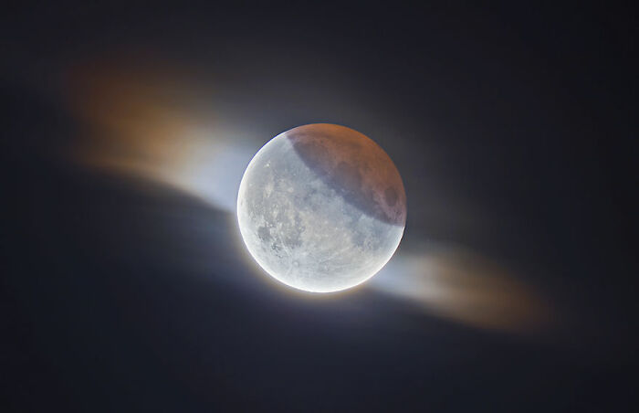 The moon during a partial lunar eclipse, showcasing vivid space colors and atmospheric effects.