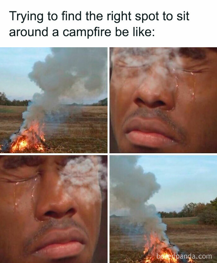Man struggling with campfire smoke while sitting outside, highlighting awkward life moments.