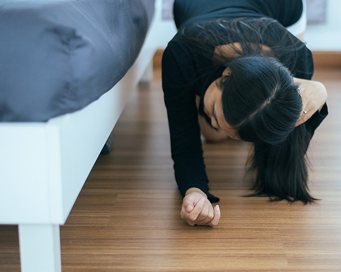 Babysitter looking under bed for monsters, finds an unexpected man hiding.