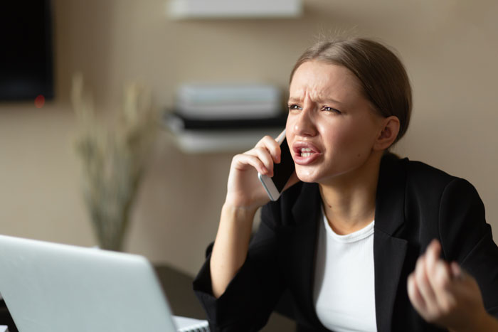 Woman on phone looks upset, discussing child abandonment concerns.