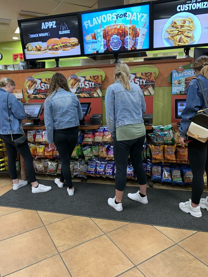 Women in a store, wearing similar denim jackets, aligning with the beauty standards and trends theme.
