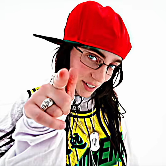 Person in a red hat and glasses pointing, wearing a basketball jersey, causing chaos described as a Billie Eilish look-alike.