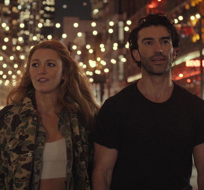 Blake Lively and a companion walk under city lights, involved in legal drama discussions.