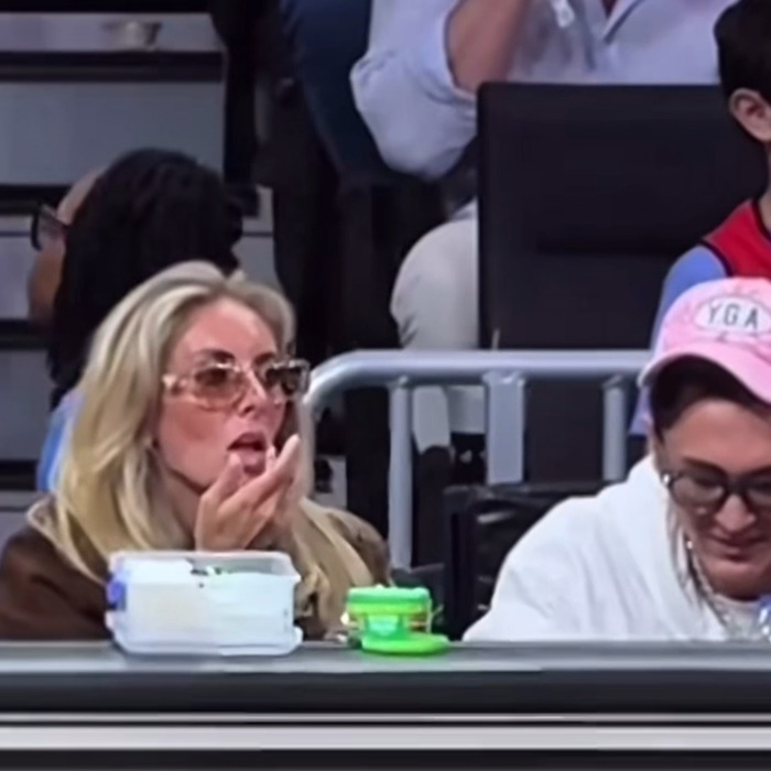 Woman in sunglasses at NBA event, sparking outrage with her actions.