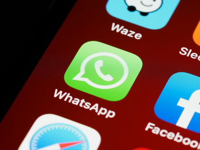 WhatsApp app icon on a smartphone screen, capturing adult experiences.