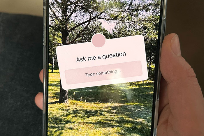 Phone with question box over a scenic background, relating to a bride confused about wedding guest choices.