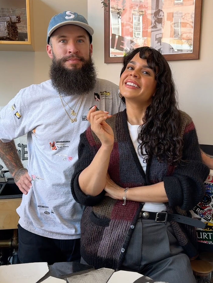 NYC cafe attracts thousands; visitors pose cheerfully inside. NYC cafe attracts thousands; visitors pose cheerfully inside.