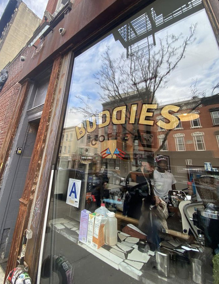 NYC cafe window with street reflections and people inside. NYC cafe window with street reflections and people inside.