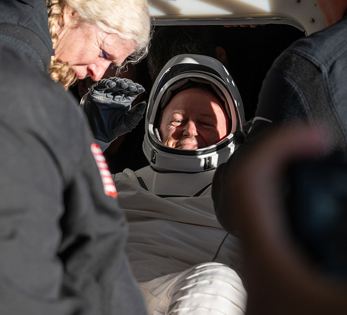 Doctor assists stranded astronaut in spacesuit, sparking concern.