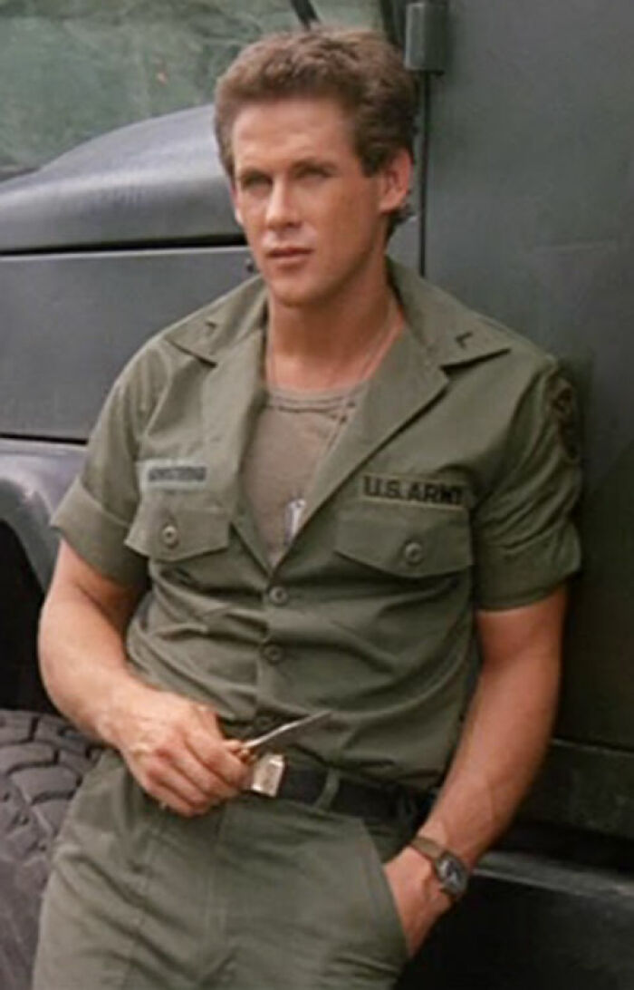 Man in military uniform leaning on a vehicle, representing celebs disappearing from media.