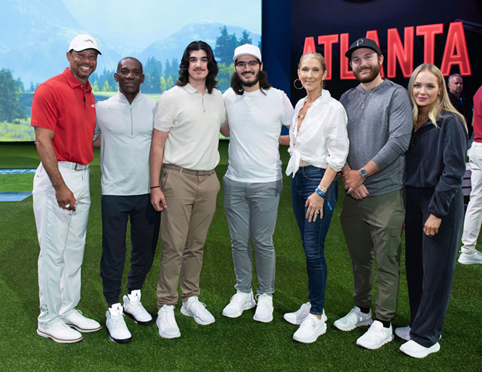Céline Dion with her bearded twin sons and other individuals posing in a group. Céline Dion with her bearded twin sons and other individuals posing in a group.