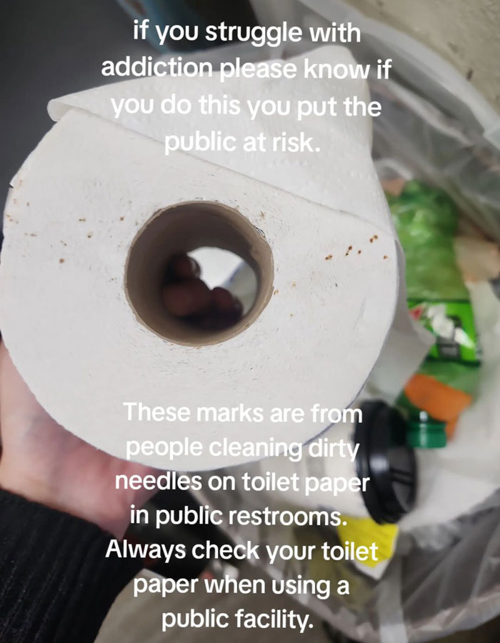 Toilet paper with hidden needle marks warning in public restrooms.