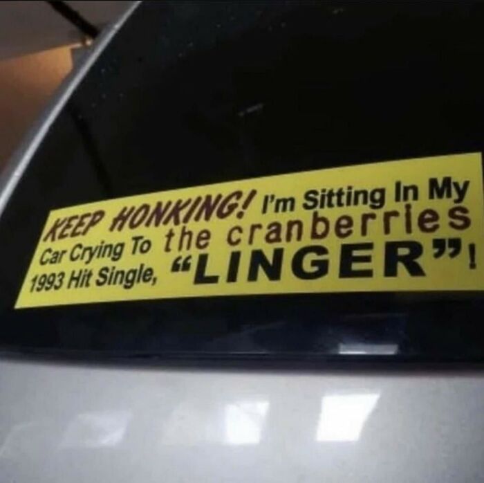 Car bumper sticker humorously references giving up on life, featuring Cranberries' "Linger" lyrics.