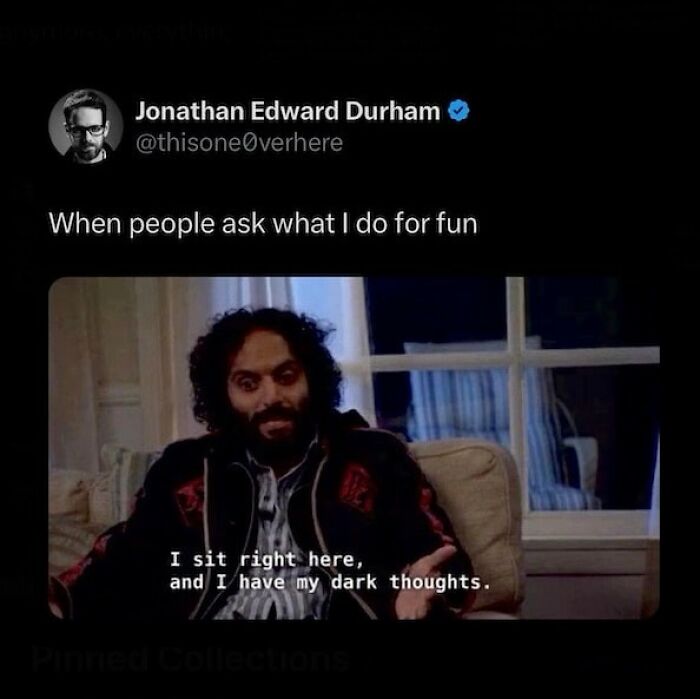 Man on a sofa jokingly shares he has dark thoughts for fun, embodying cheerful nihilism.