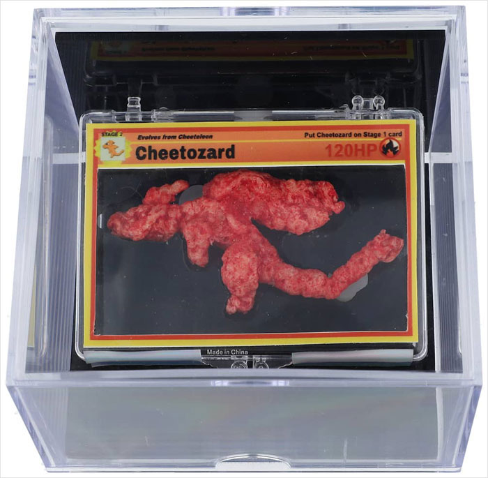 Pok&eacute;mon-shaped Cheeto in a display case, resembling a game card, purchased for $88K at auction.