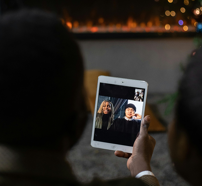 Person using a tablet for a video call with childfree friends during holiday season. Person using a tablet for a video call with childfree friends during holiday season.