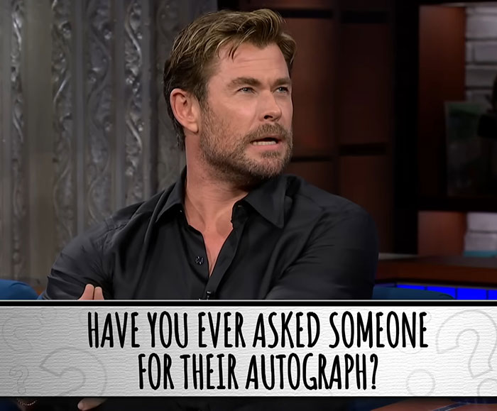 Chris Hemsworth discussing a question about autographs on a talk show, reflecting on past experiences.