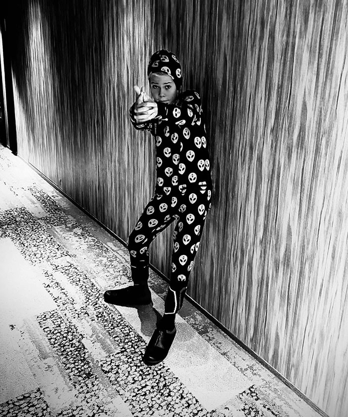 Child in Halloween pajamas striking playful pose, linked to Chris Hemsworth photo controversy. Child in Halloween pajamas striking playful pose, linked to Chris Hemsworth photo controversy.