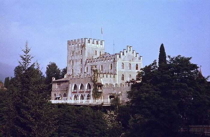 Castle surrounded by trees, symbolizing Napoleon returning from exile with a historical ambiance.