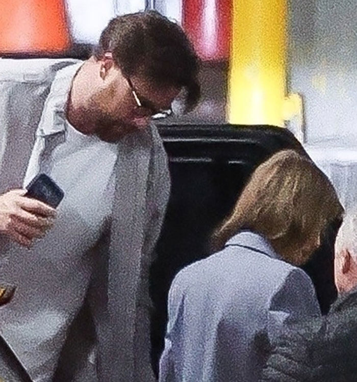 A couple steps out of a car, sparking rumors and reactions about Taylor Swift's date night outfit choice.