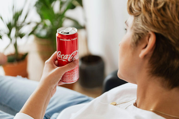 A person sitting with a can of soda, reflecting on a 10-year-old tribute to a friend's late mom. A person sitting with a can of soda, reflecting on a 10-year-old tribute to a friend's late mom.