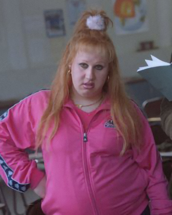 Fictional character Vicky Pollard in a pink track jacket with long hair and scrunchie. Fictional character Vicky Pollard in a pink track jacket with long hair and scrunchie.