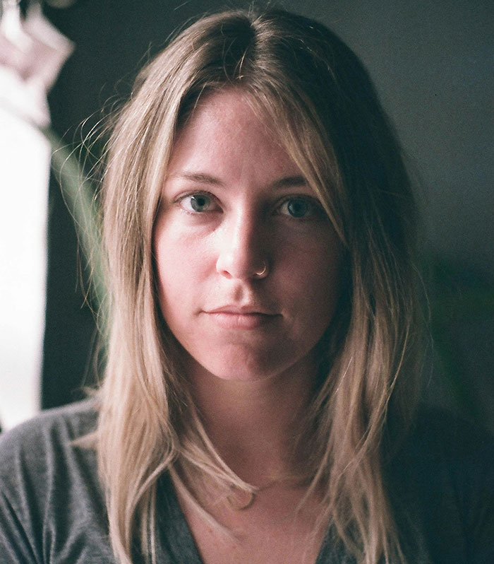 Portrait of a person with psychological tricks expression, brown hair, soft lighting.
