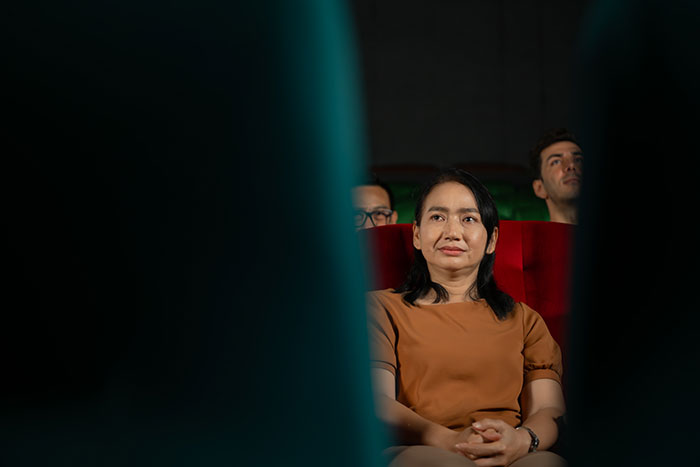 Person in an audience setting experiencing unexpected cultural differences.