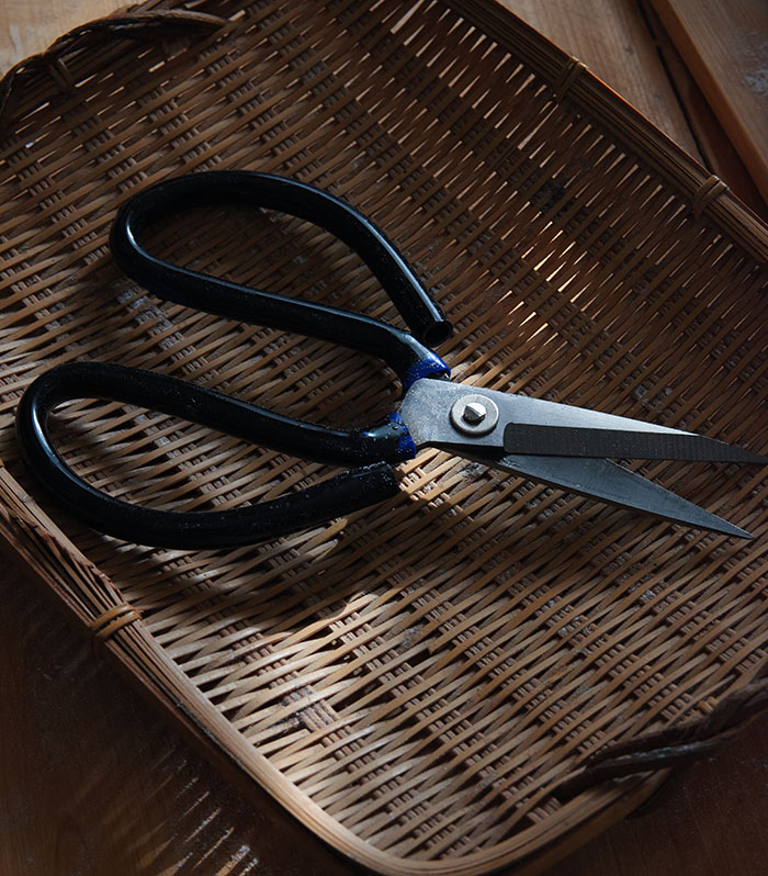 Scissors on a woven basket highlighting unexpected cultural differences in tools.