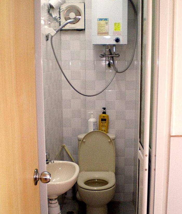 Compact bathroom setup showcasing unexpected cultural differences in plumbing design.