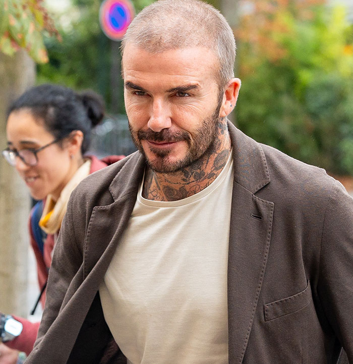 David Beckham in casual attire outdoors, related to ex-assistant's interview on affair rumors.