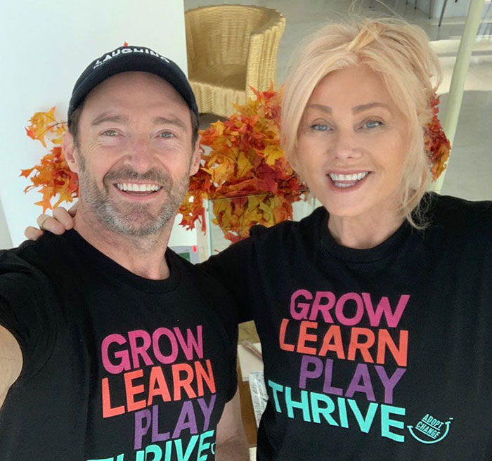 Smiling couple in matching shirts with autumn leaves; Hugh Jackman and Deborra-Lee divorce news context.